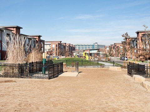 a park with a playground and buildings in the background