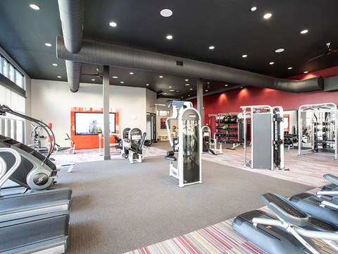a gym with cardio equipment and weights in a building