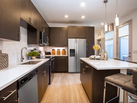 a kitchen with a large counter and a refrigerator
