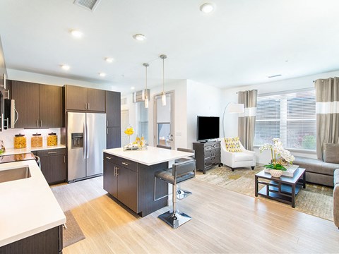 a kitchen and living room with an island in the middle