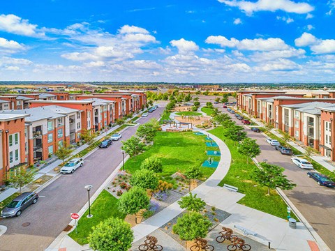 an aerial view of a street with houses and a park