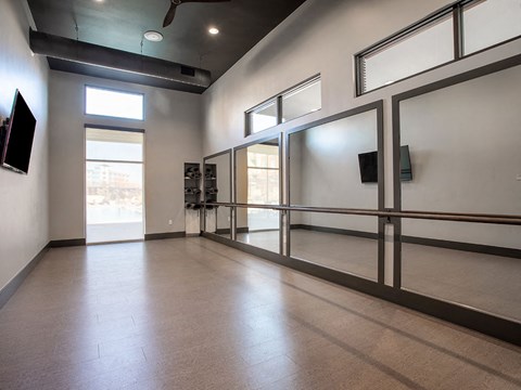 an empty room with glass doors and a window