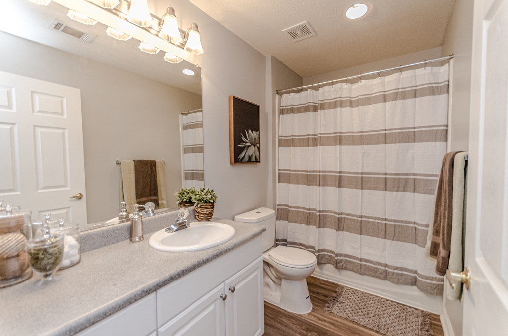 a bathroom with a shower and a sink and a toilet