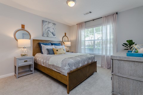 a bedroom with a large bed and a window