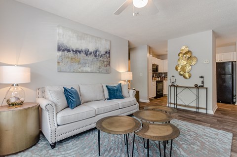 a living room with a couch and three tables