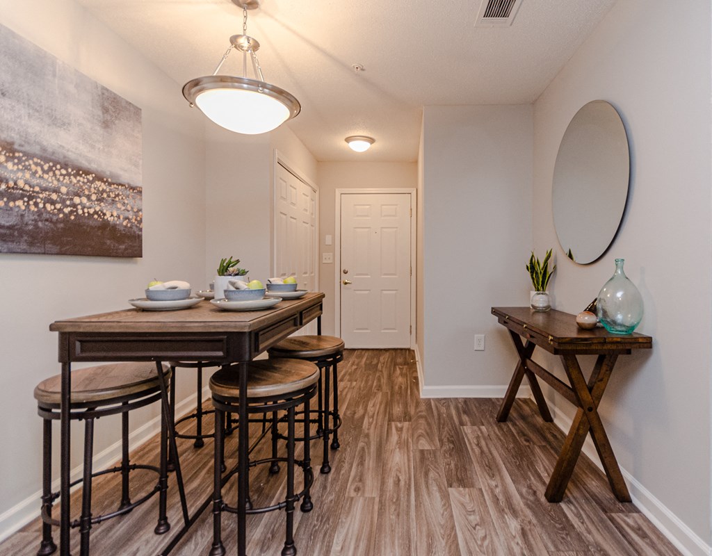 a dining room with a wooden table and stools