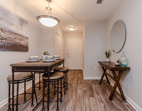 a dining room with a wooden table and stools