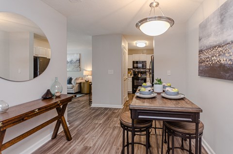 an open living room and dining room with a table and chairs