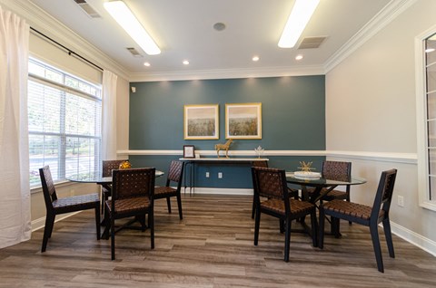 a dining room with a table and chairs and a window
