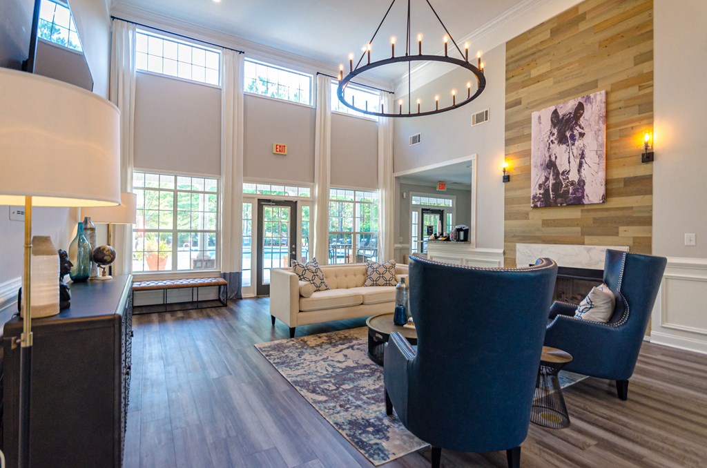 a living room with couches and chairs and a chandelier