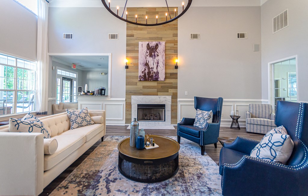 a living room with couches and chairs and a fireplace