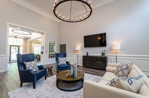 a living room with blue and white furniture and a tv
