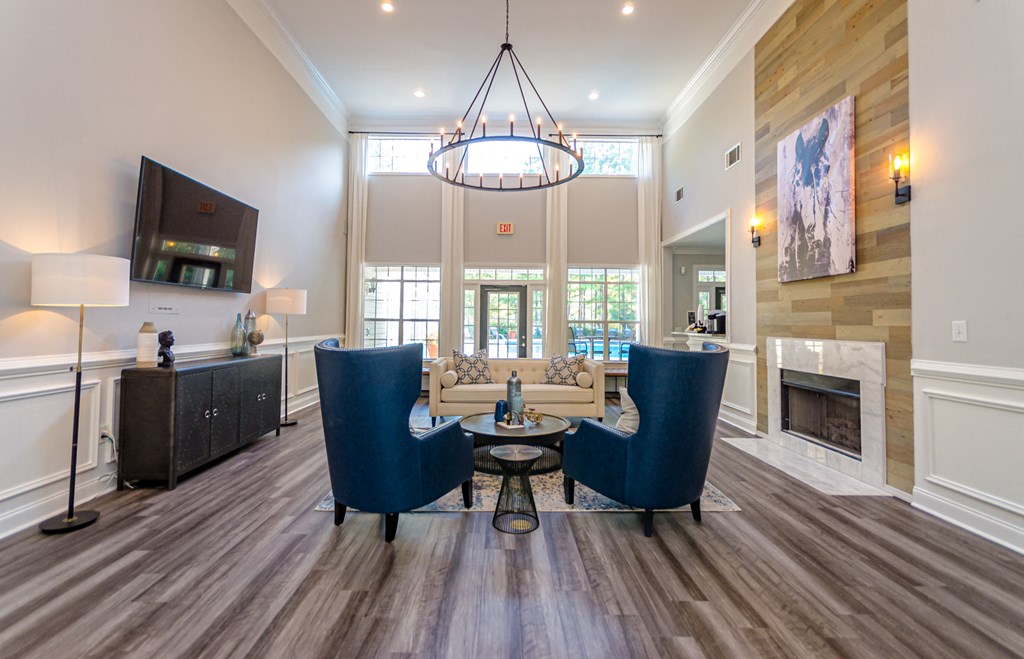 a living room with a table and chairs and a fireplace