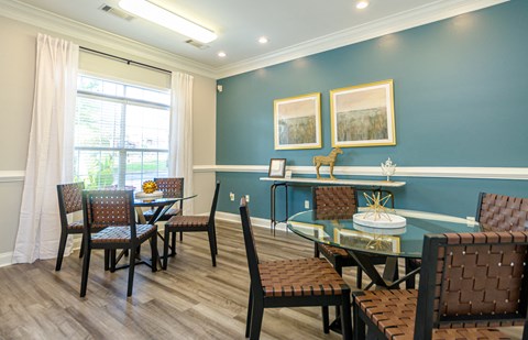 a dining room with a table and chairs and a window