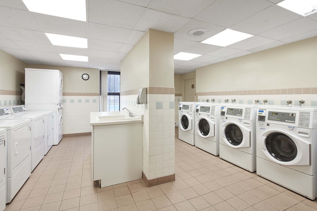 a laundry room filled with lots of washes and dryers