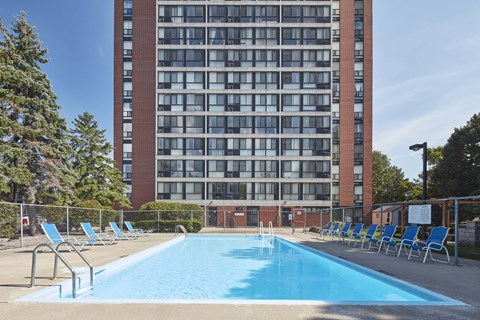 a swimming pool at a hotel in front of a building