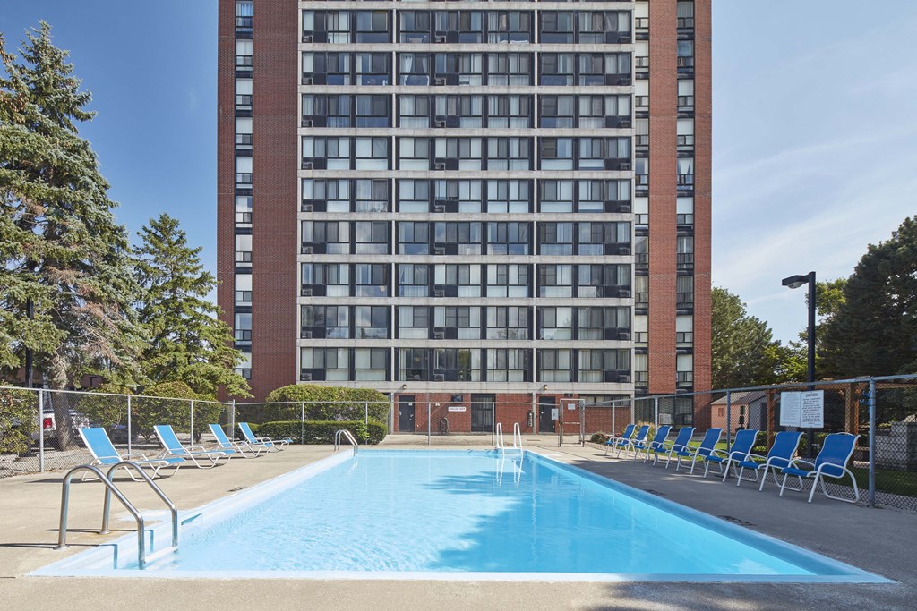 a swimming pool at a hotel in front of a building