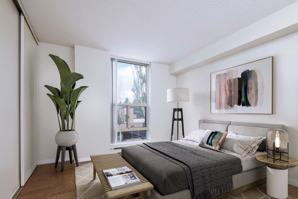 a bedroom with a bed and a large window