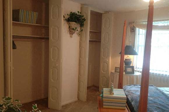 a bedroom with a bed and a book shelf