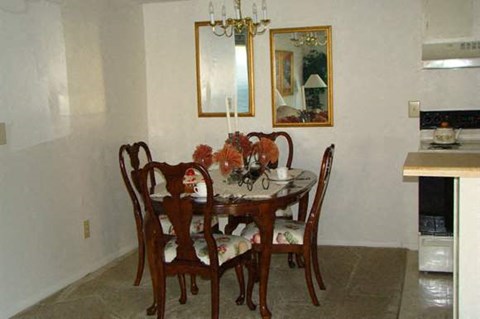 a dining room with a table and chairs