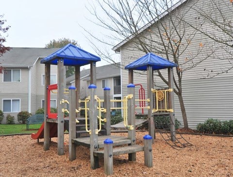 a playground is shown in front of a house