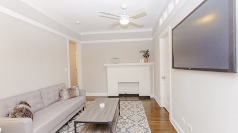 a living room with a couch and a tv and a fireplace