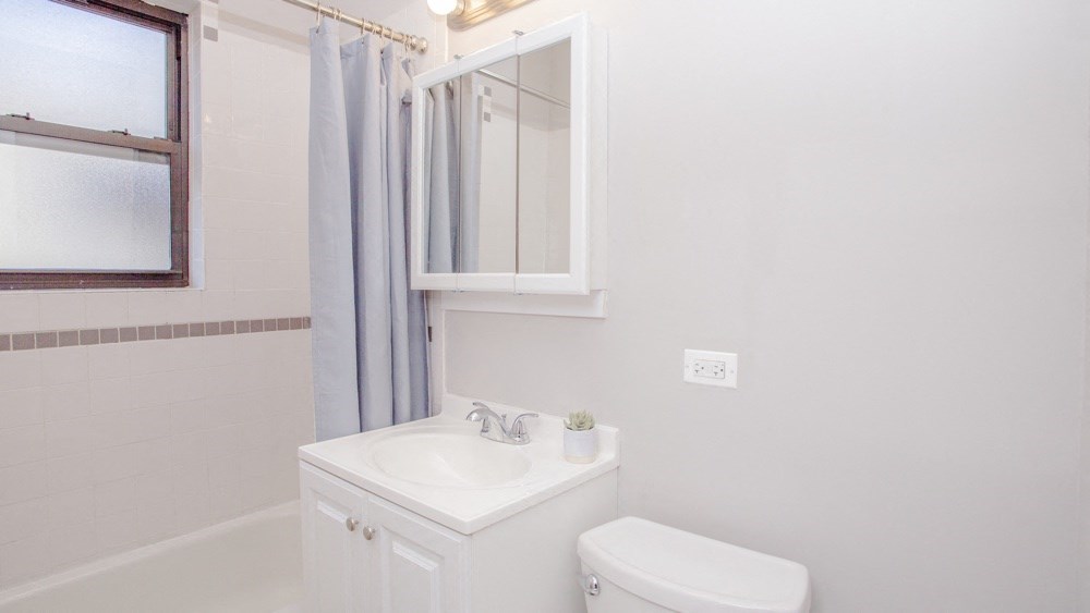 a bathroom with a sink and a mirror and a toilet
