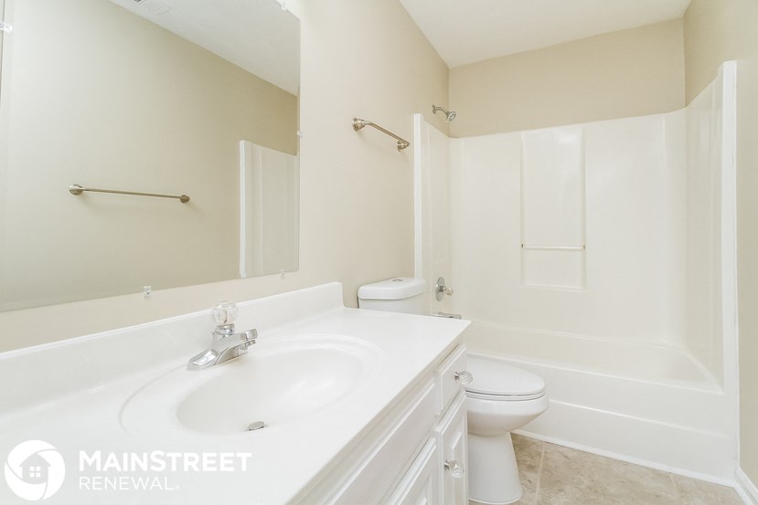 a bathroom with a sink and a toilet and a bath tub