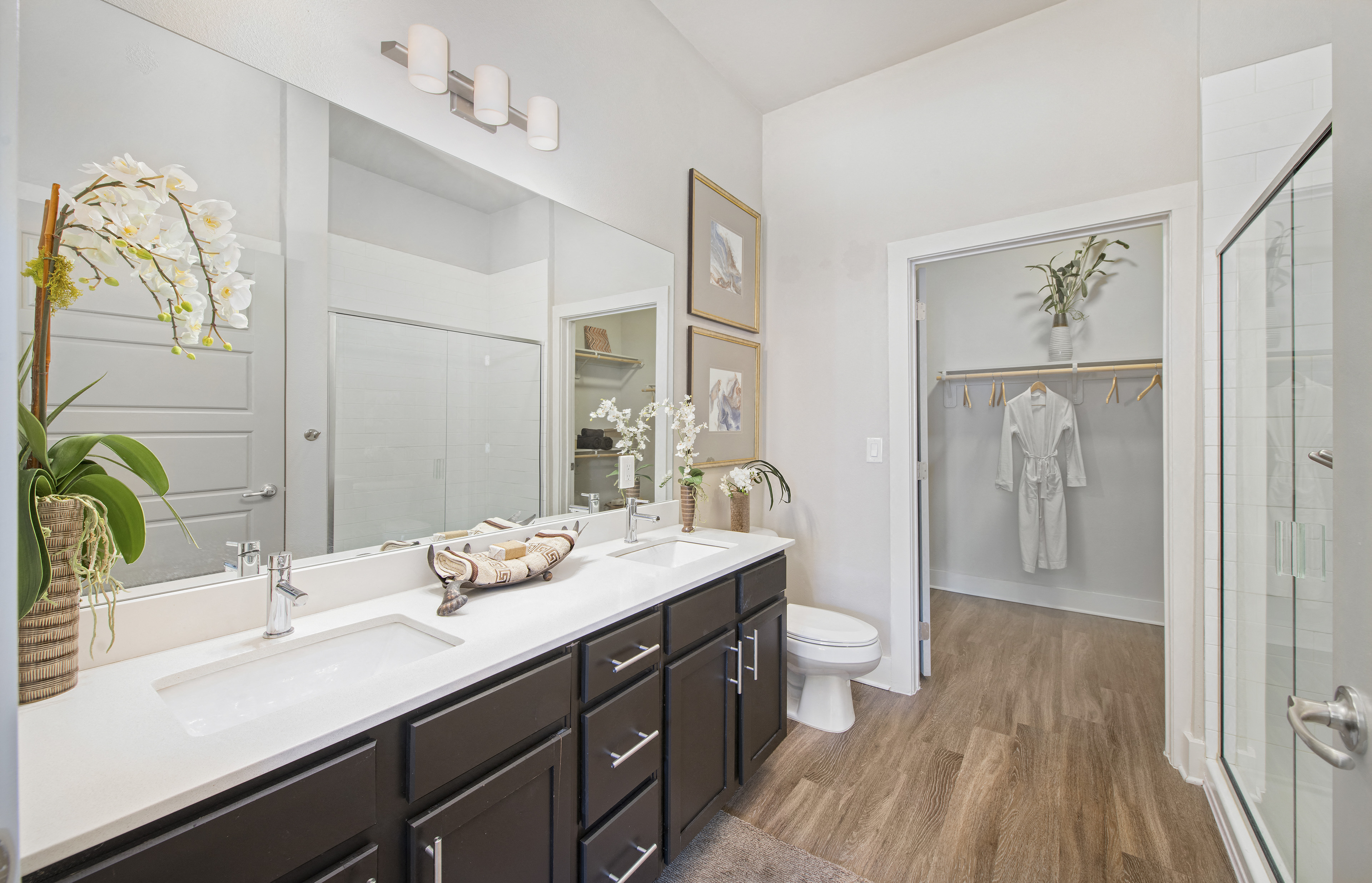 a bathroom with a large mirror and a sink and a toilet