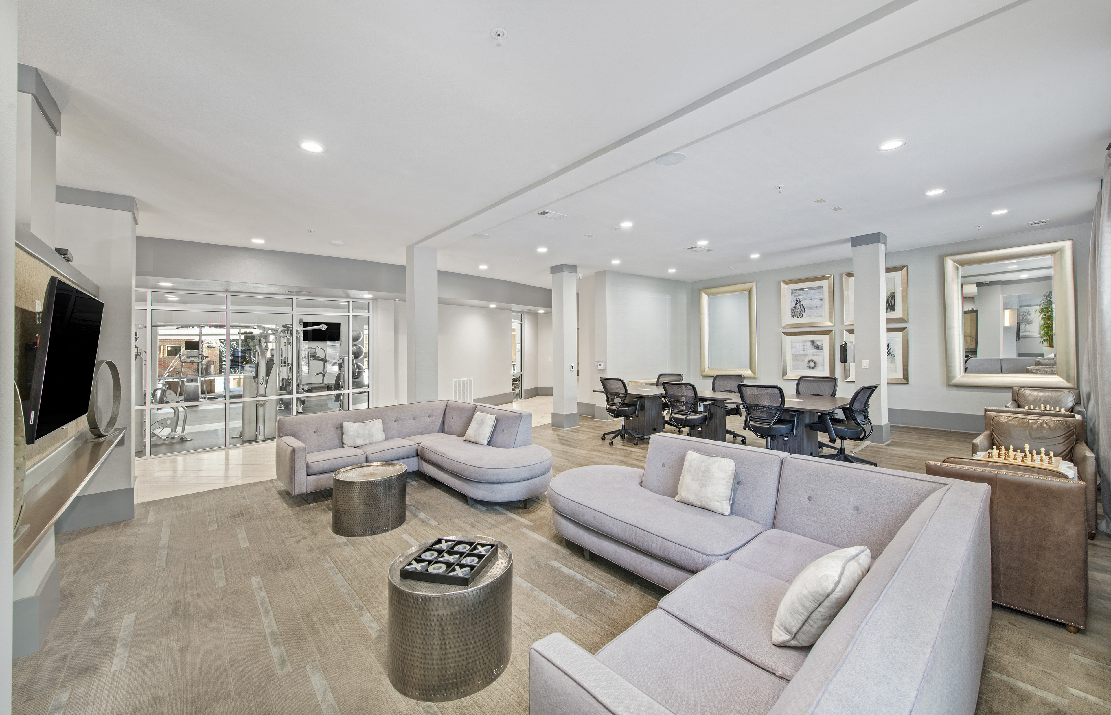 a living room with couches and chairs and a bar