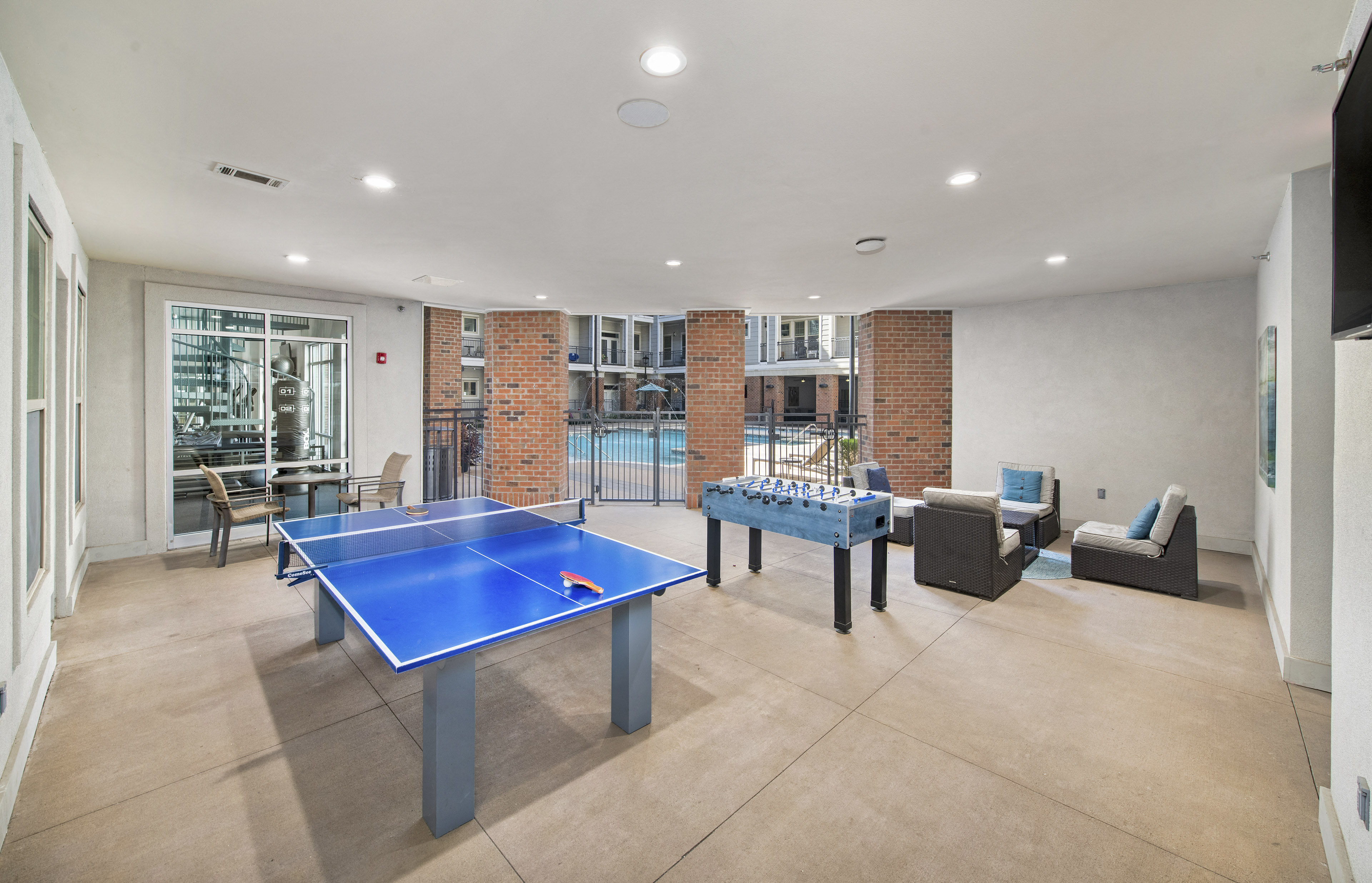 two ping pong tables in a living room with a pool table