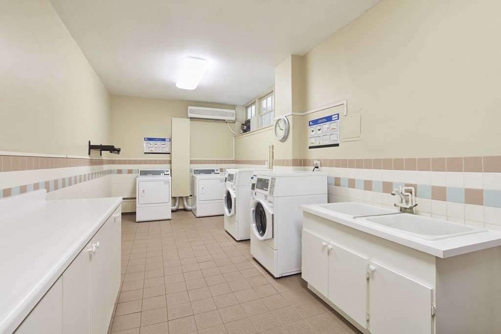 a laundry room with washers and dryers and sinks