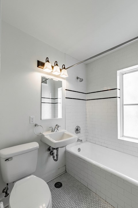 a white bathroom with a toilet sink and tub