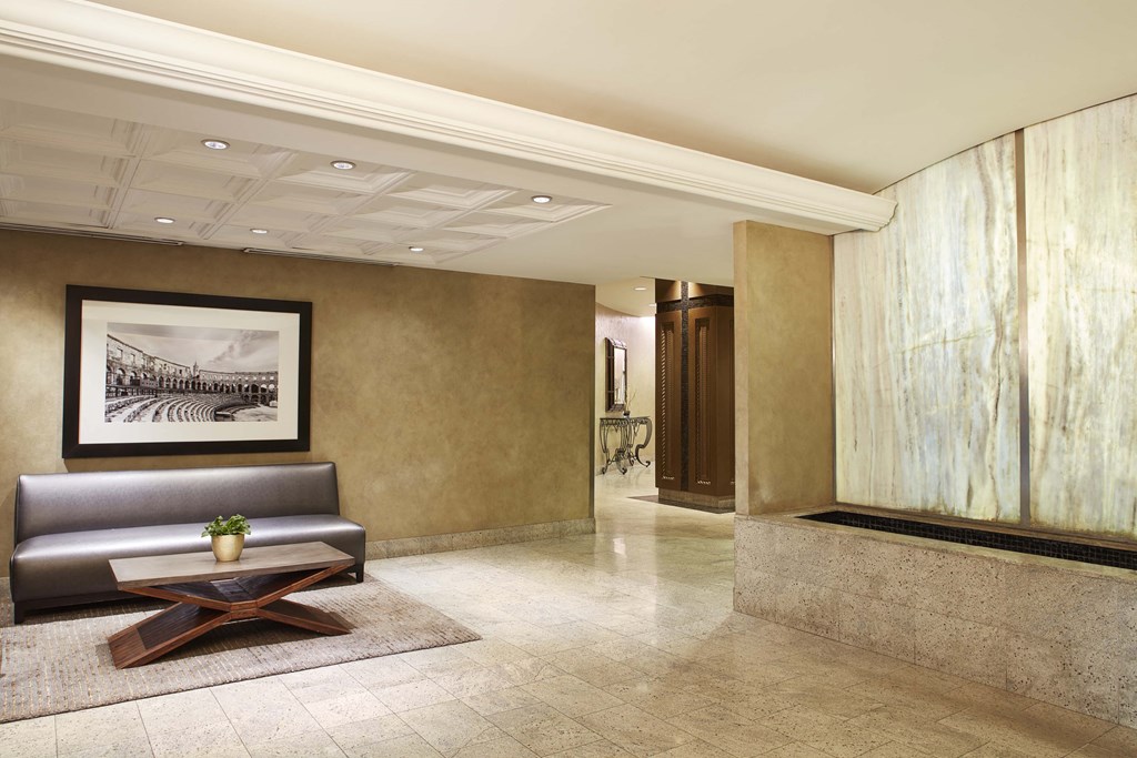 a lobby of a hotel with a couch and a coffee table