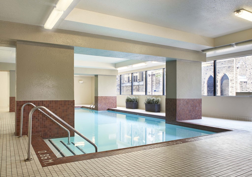 a swimming pool in a large room with a large window