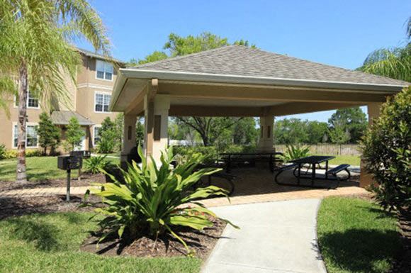 a pavilion with a picnic table in a park