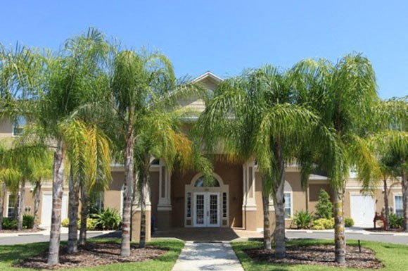 a house with palm trees in front of it