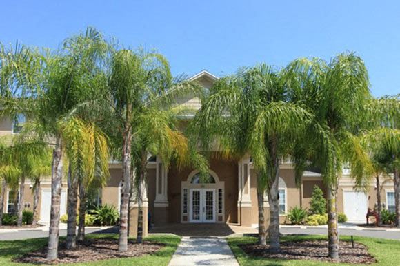 a house with palm trees in front of it