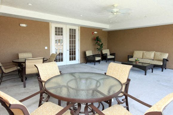 a living room with a glass table and chairs