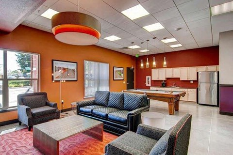 a living room and kitchen with a pool table