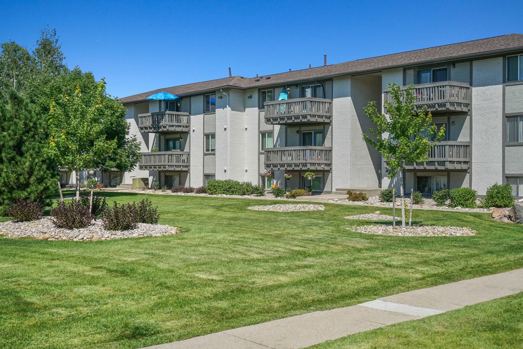 an exterior view of a building with grass and trees