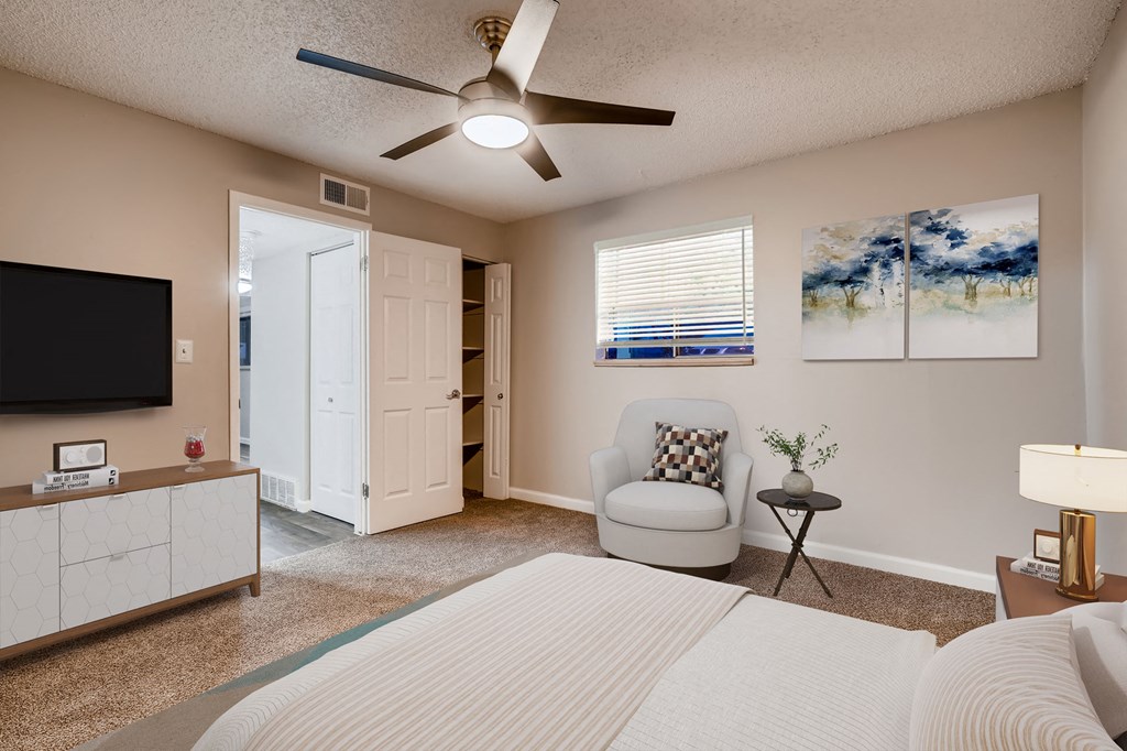 a bedroom with a bed and a ceiling fan