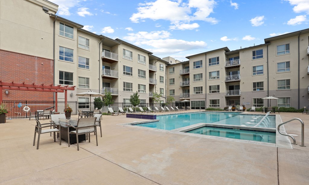 our apartments have a swimming pool and a patio with chairs and tables