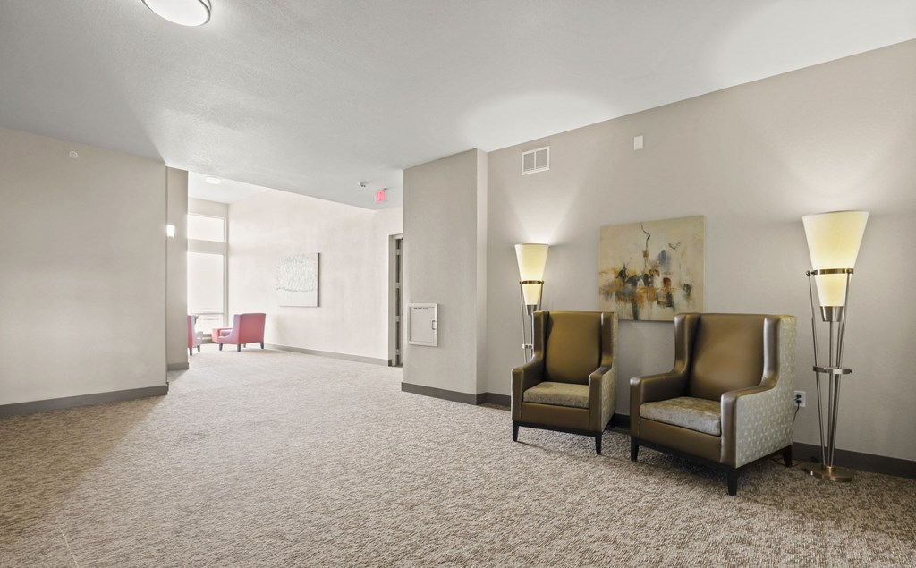 a large room with chairs and lamps and a large window