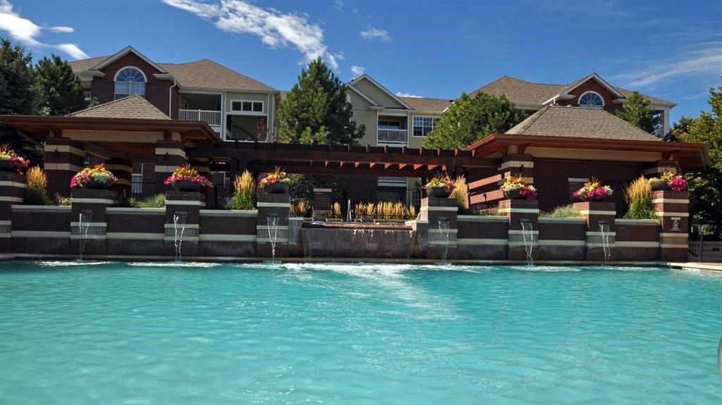 a swimming pool with a house in the background