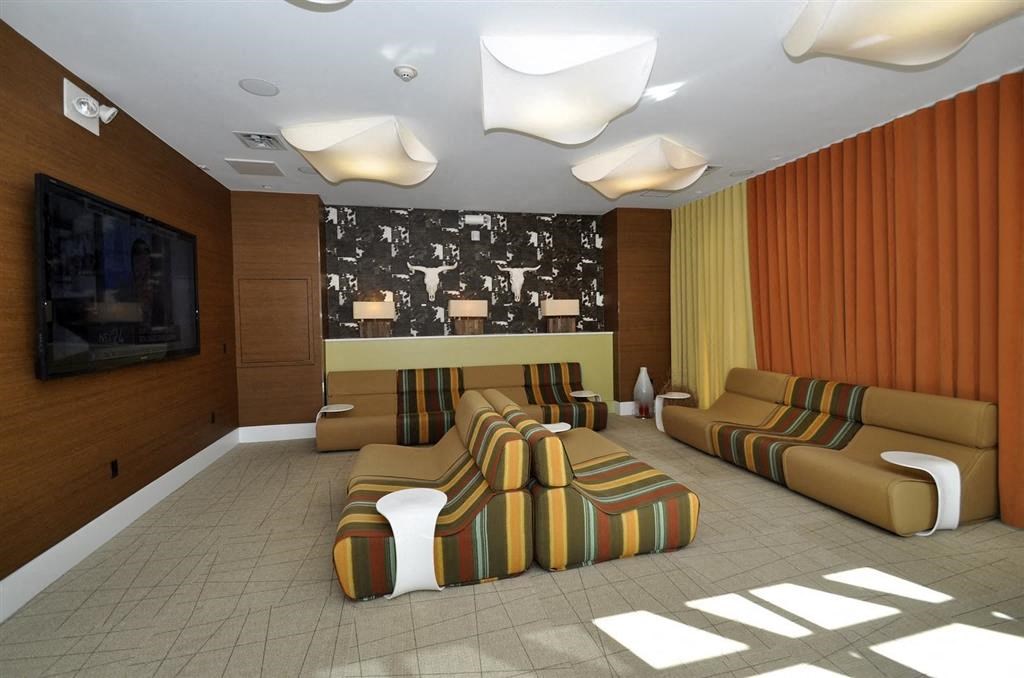 a large living room with couches and a tv