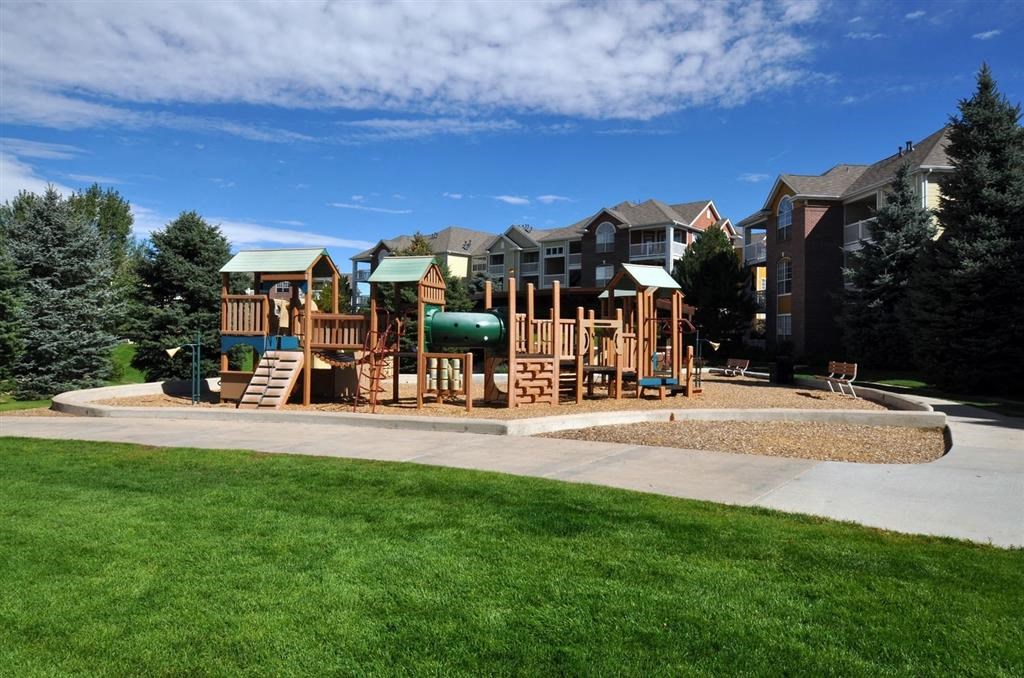 a playground with a building in the background