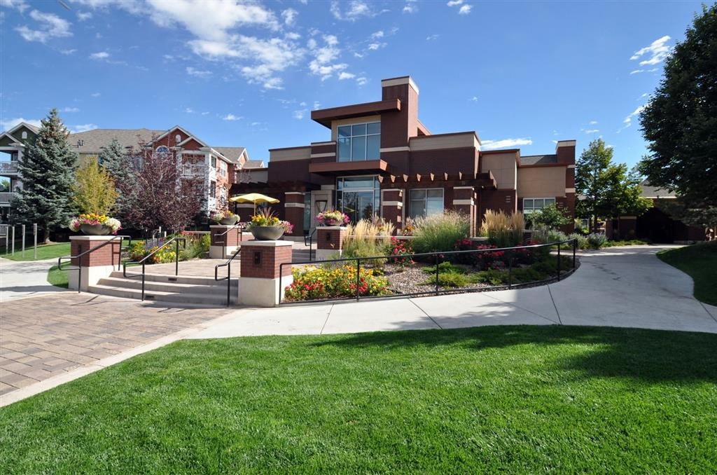 the front of a house with a yard and stairs