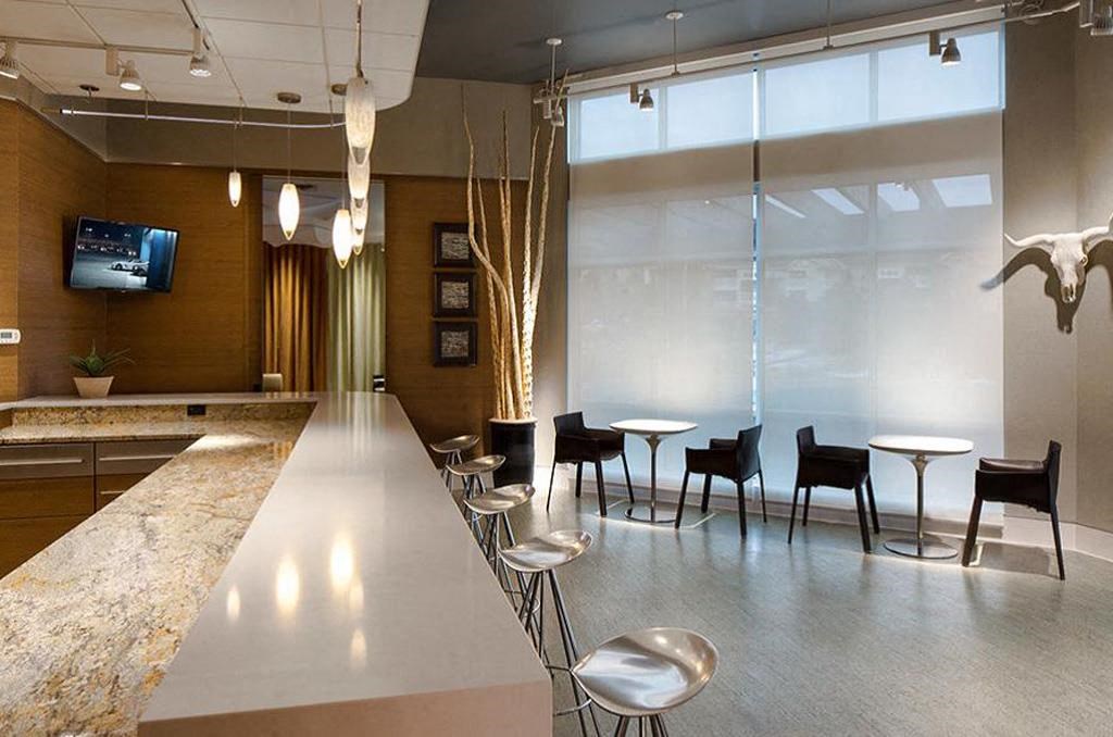 a lobby with tables and chairs and a counter