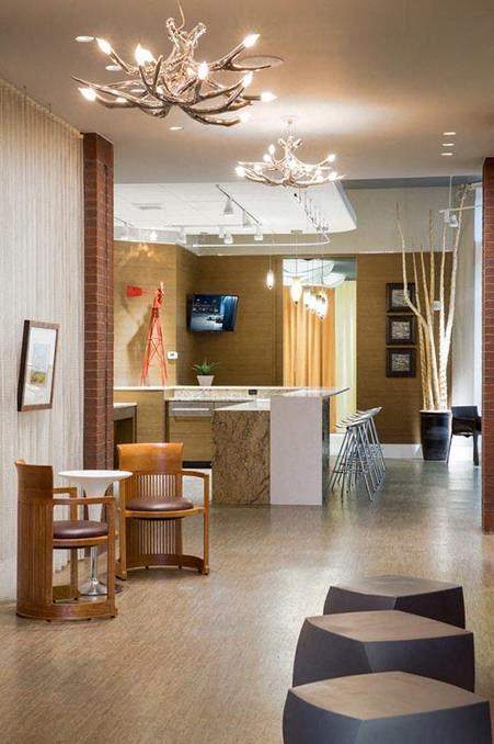 a lobby with a table and chairs and a reception desk